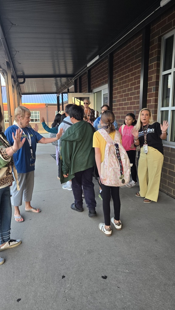 teachers high-fiving students