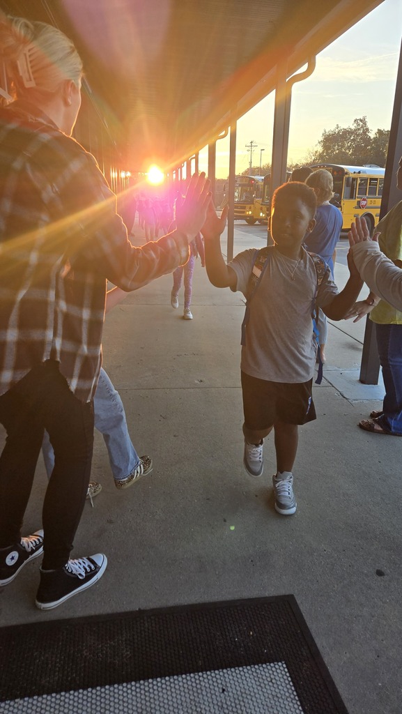 teachers high-fiving students