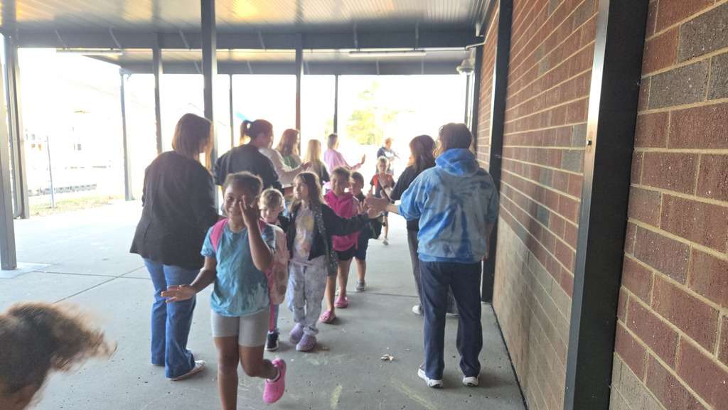 teachers high-fiving students