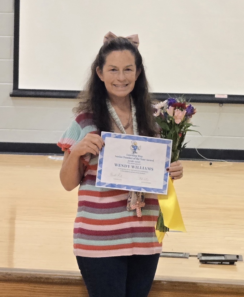 Teacher of the Year with flowers and certificate