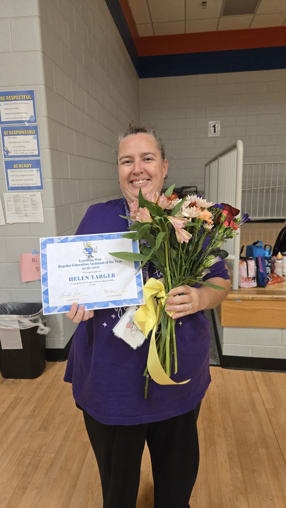 Assistant of the Year with flowers and certificate