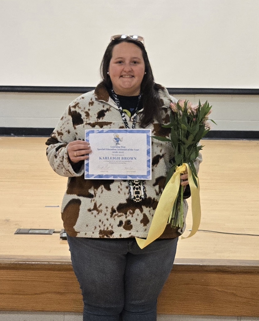 Assistant of the Year with flowers and certificate