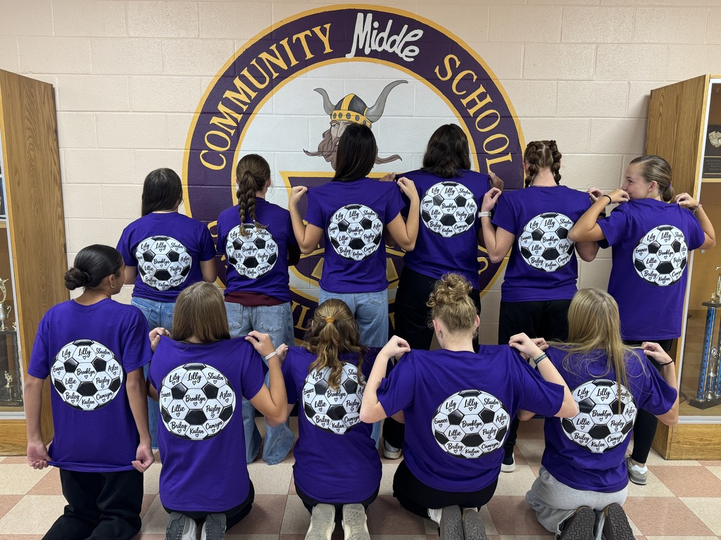 girls showing off the back of their t shirt