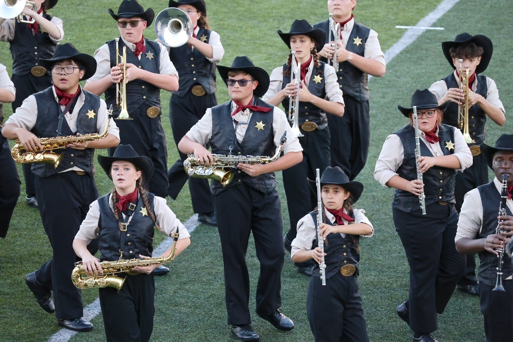 The Cascade High School marching band is on the football field during their performance. 