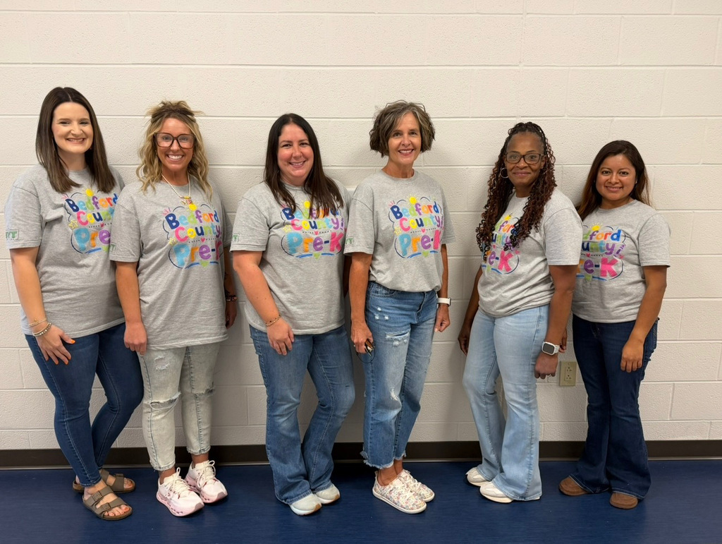 A group of Pre-K teachers are posed for a picture wearing matching t-shirts.
