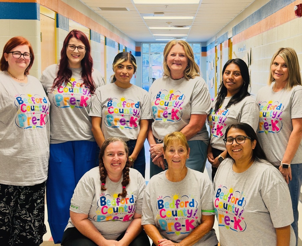 A group of Pre-K teachers are posed for a picture wearing matching t-shirts.