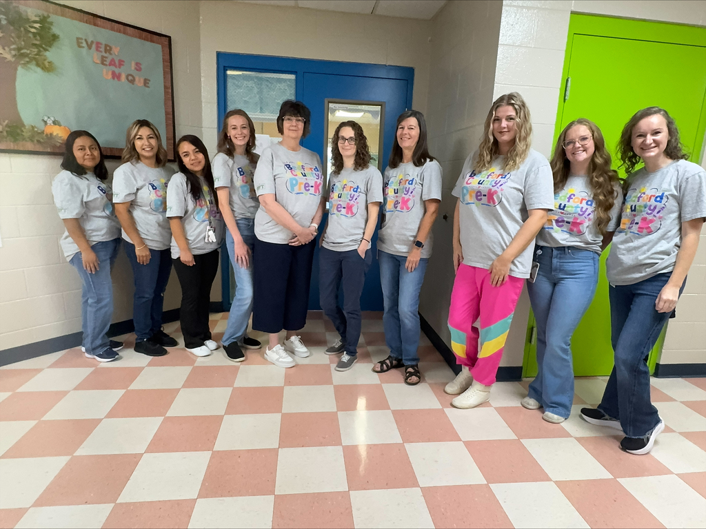 A group of Pre-K teachers are posed for a picture wearing matching t-shirts.