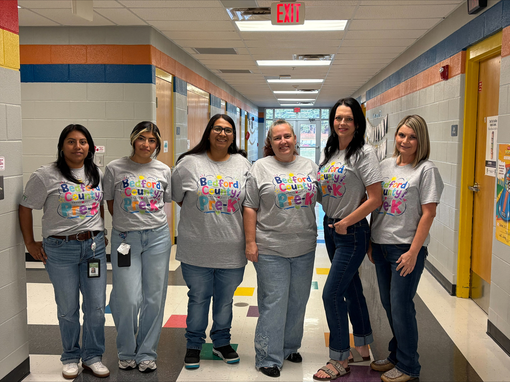 A group of Pre-K teachers are posed for a picture wearing matching t-shirts.