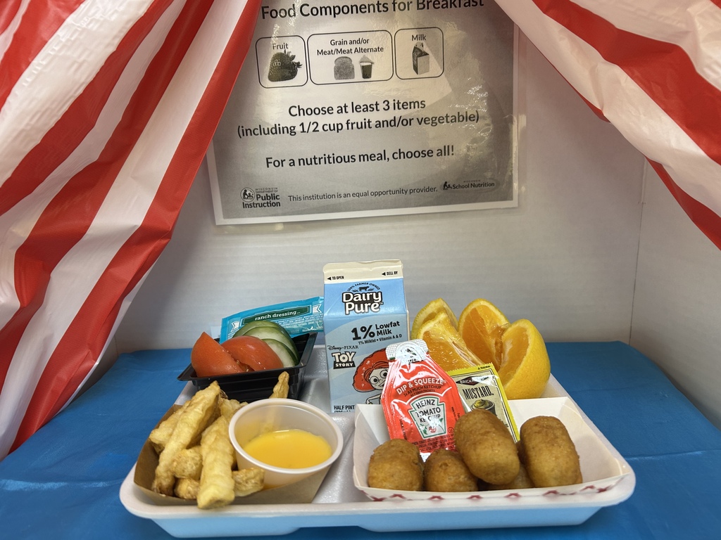 A school lunch tray has a fruits, vegetables and corndogs and french fries on it along with a carton of milk. 