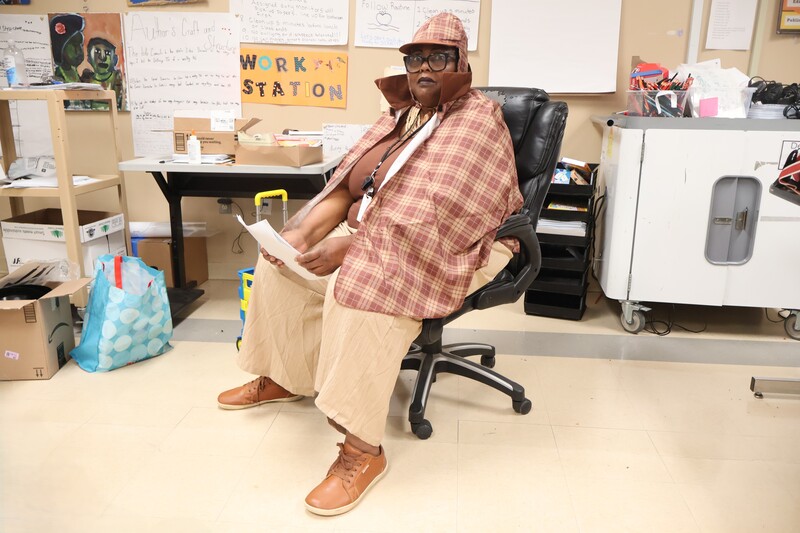 The teacher is posed for a picture wearing a costume.