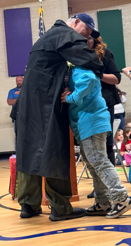 student hugging veteran