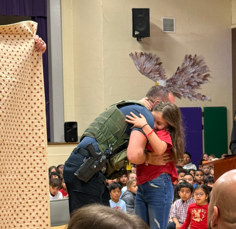 student hugging veteran