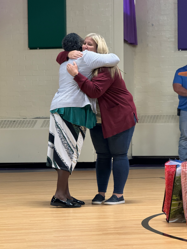 staff hugging veteran