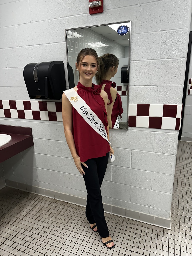 Zoe placing sticker on mirror