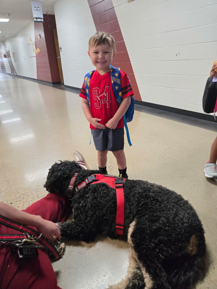 pre-K students petting Boomer the dog