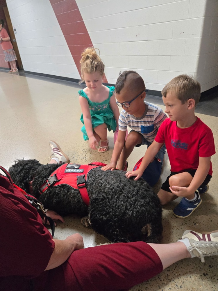 pre-K students petting Boomer the dog