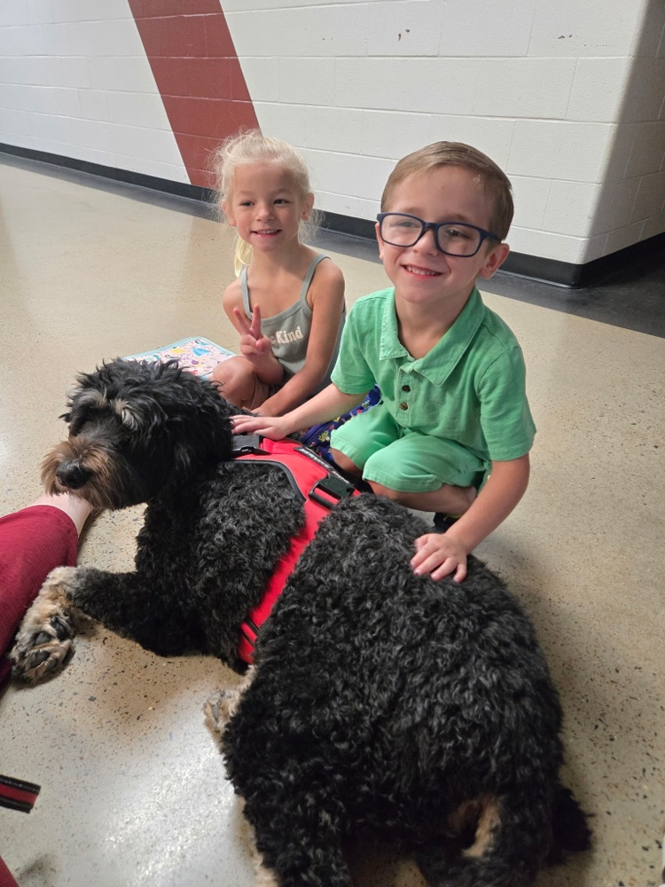 pre-K students petting Boomer the dog