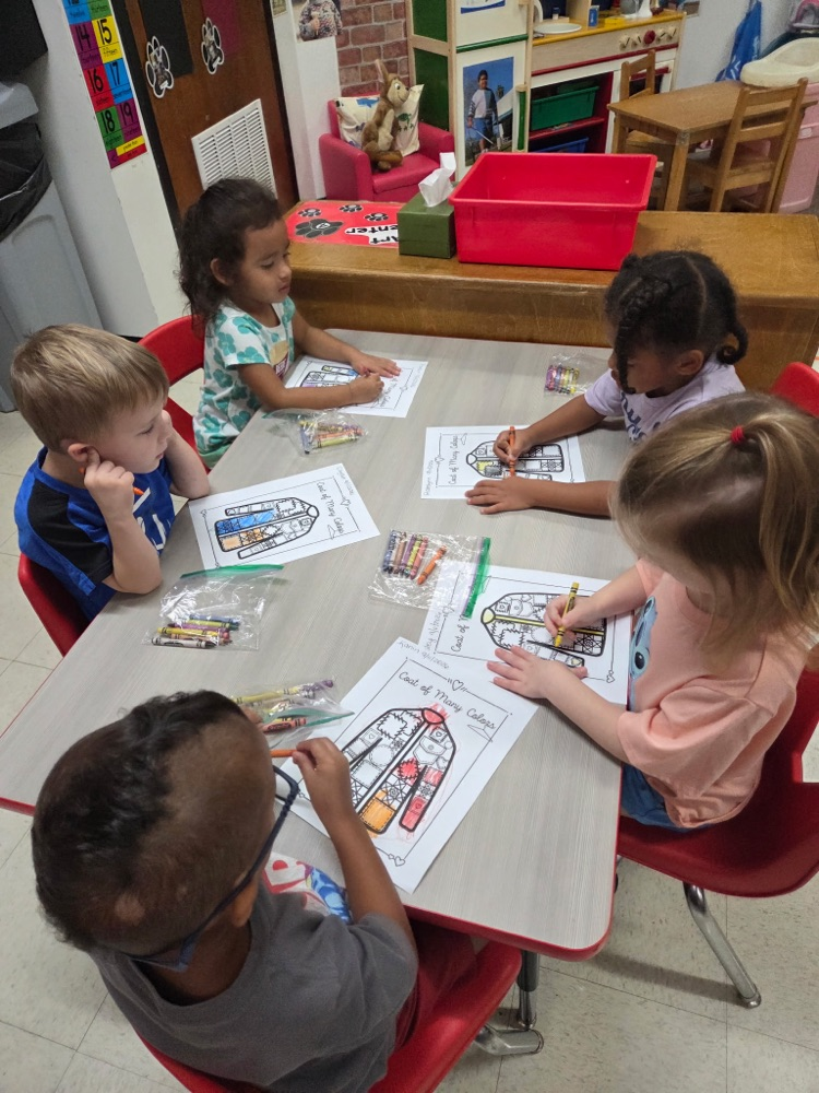 Pre-K students coloring coat of many colors