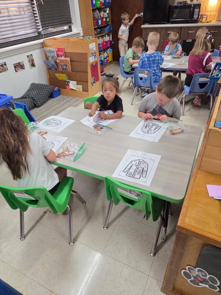 Pre-K students coloring coat of many colors