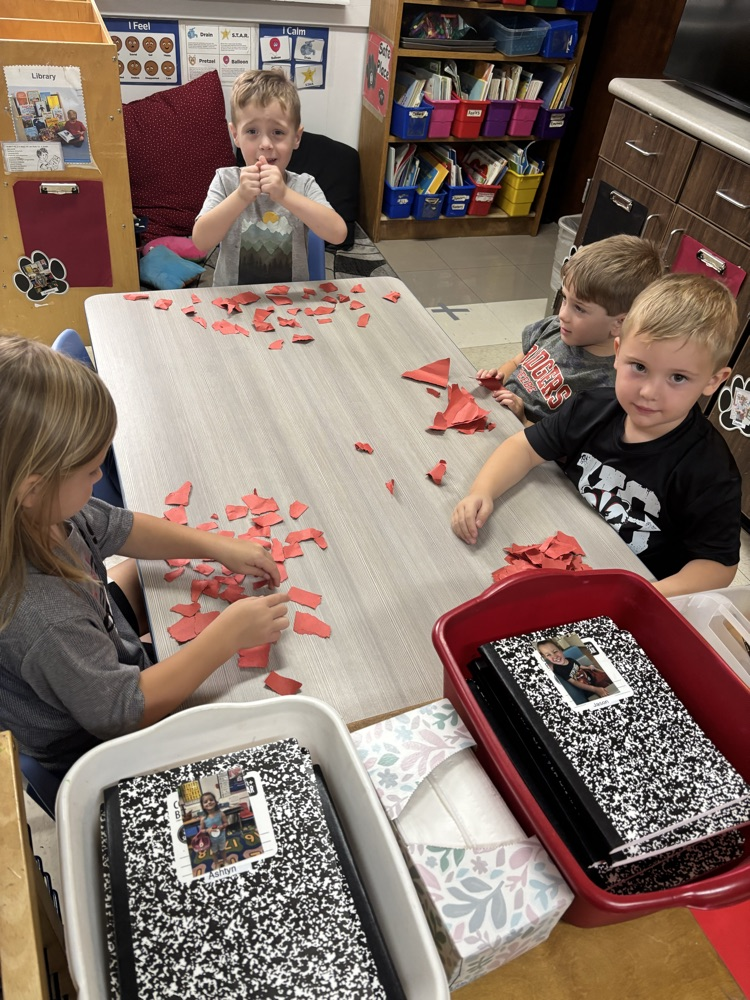 students tearing paper to make apple craft 