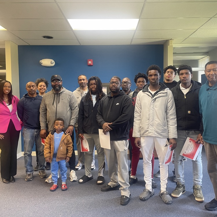 Board members recognizing the student athletes and coaching staff of the Varsity Boys Basketball team 