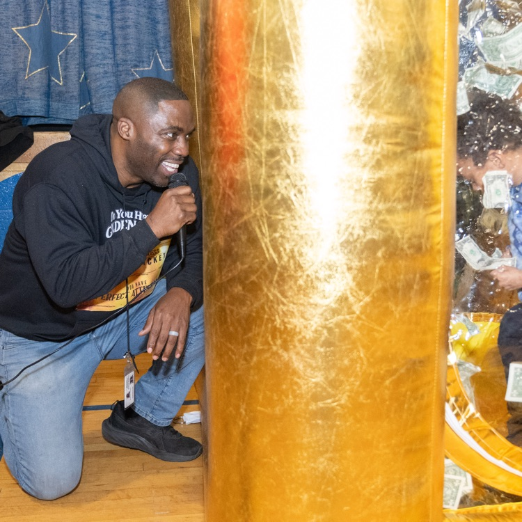 Mr. Edison cheering a student on that is in the money machine 
