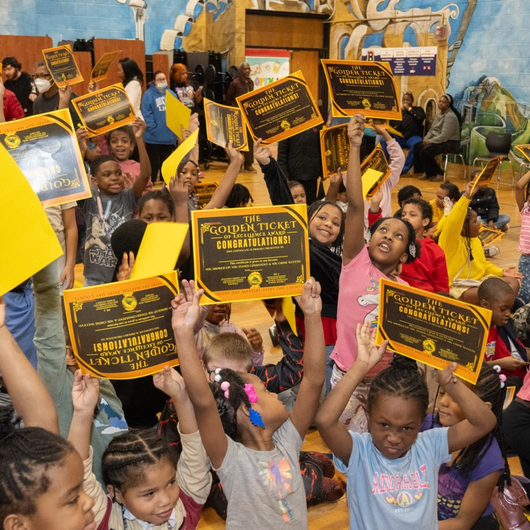 Dailey Students holding up their Golden Ticket Certificates 