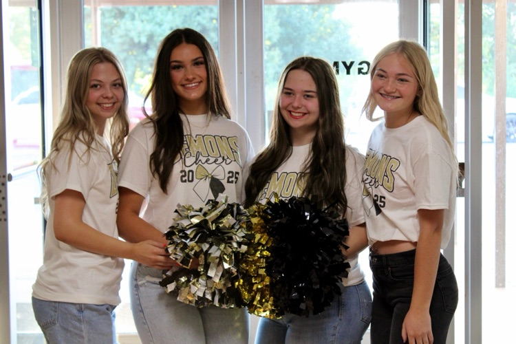 cheerleaders greet students