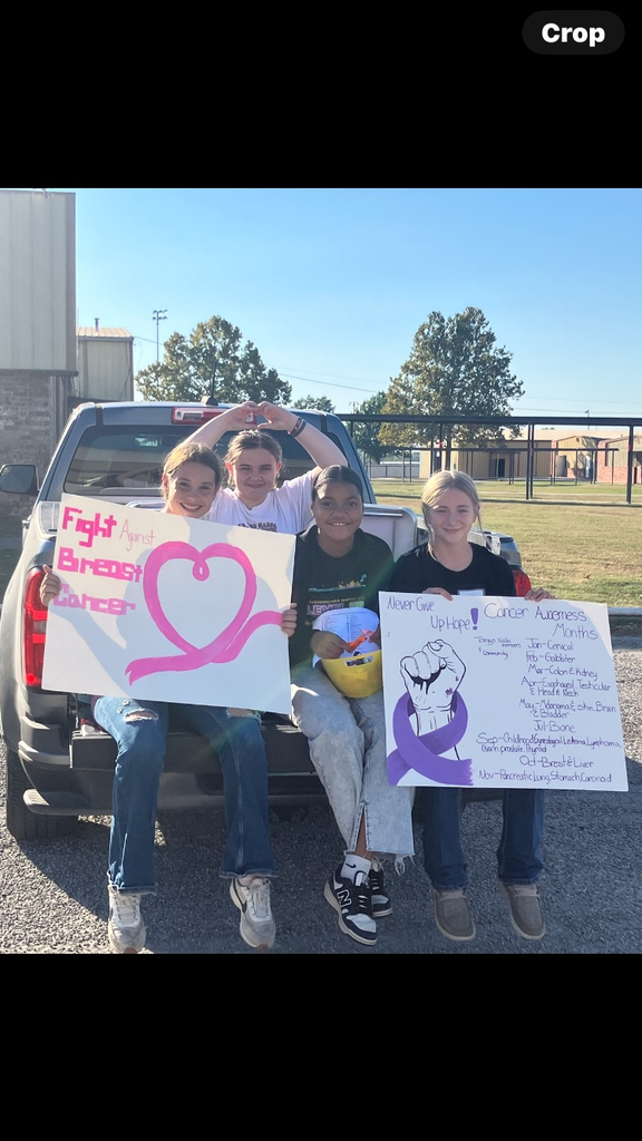 FCCLA members setting up a table for Cancer Awareness at tonight’s home football game  