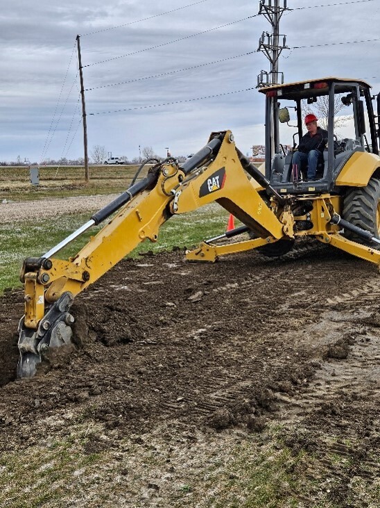 Heavy Equipment Operator Tyler Hendrickson (Sophomore) Digging trench with backhoe 