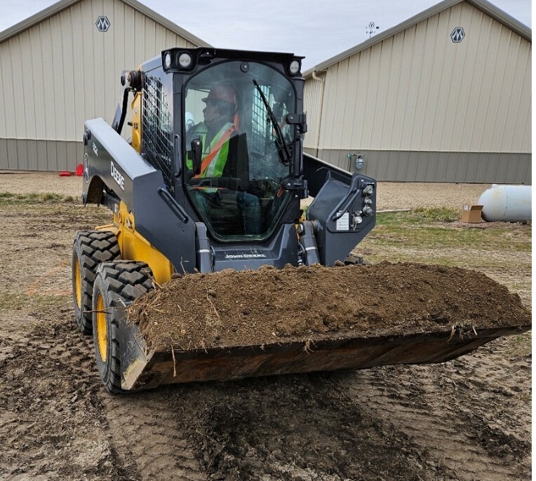 Heavy Equipment Operator Landon Tate (Junior) running skid steer obstacle course.