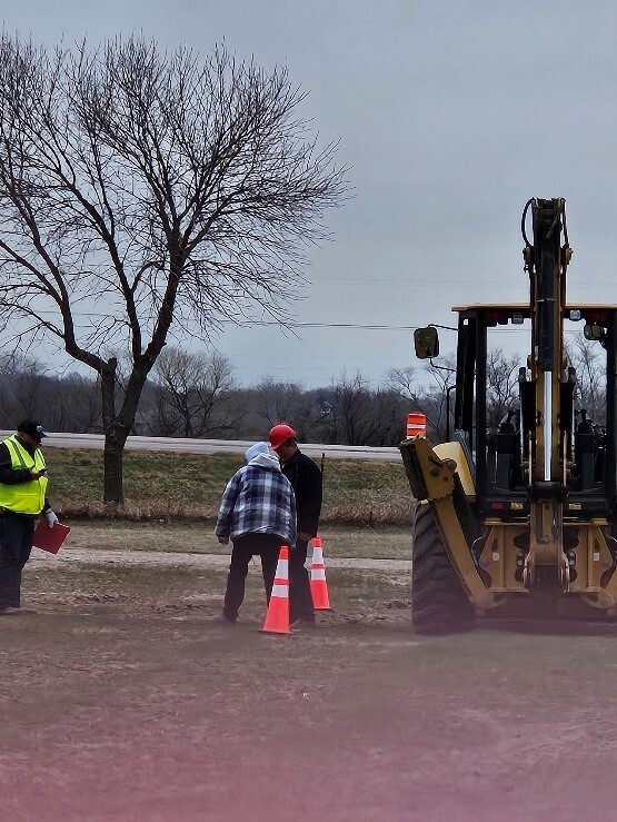 Tyler is getting ready to operate the backhoe 