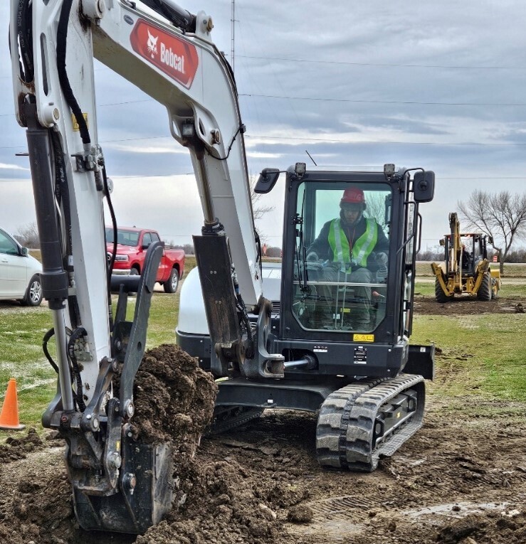 Heavy Equipment Operator Jaye Hollowhorn (Sophomore) Digging trench with mini excavator