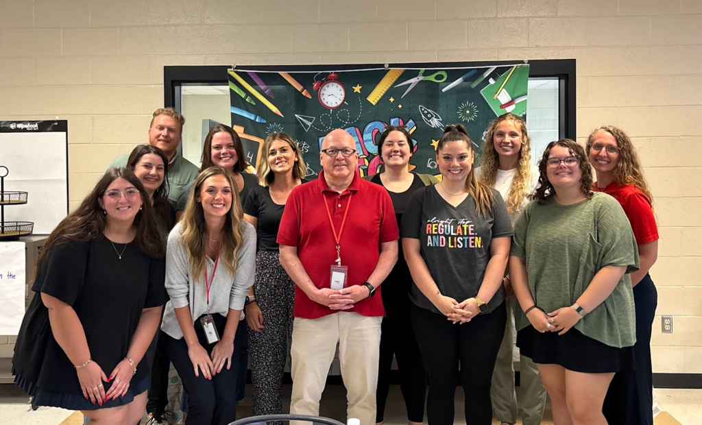 New teachers posing with Dr. Roy.