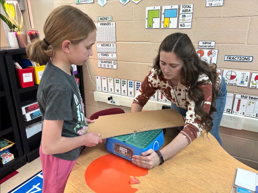 Teacher using a Chompsaw.