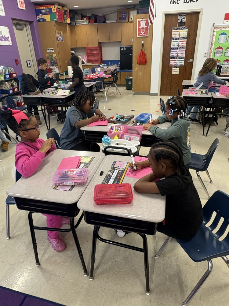 1st grade and high schoolers making Valentines 