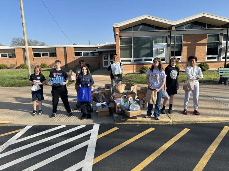 6th Graders preparing to load the bus with our food drive donations.