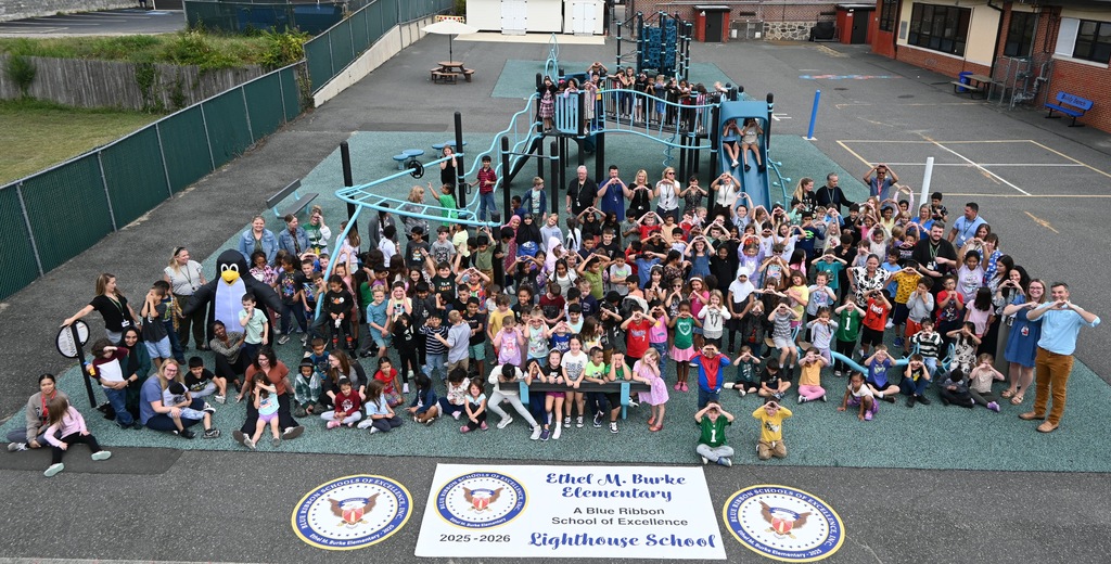 Entire school posing for picture on playground.