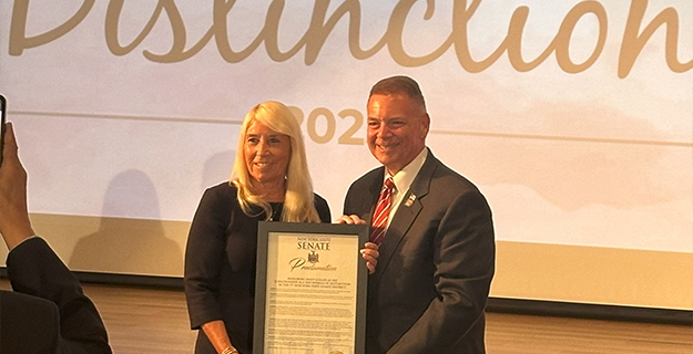 1)	Bellmore School District Board of Education Vice President Janet Goller was recognized as a Woman of Distinction by New York State Senator Steve Rhoads. 