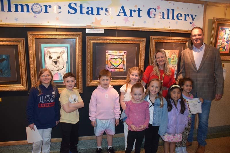 Students and teachers standing in front of art gallery.