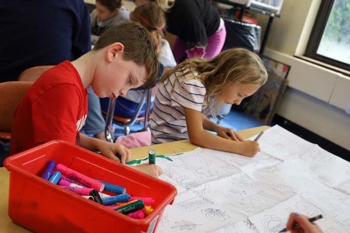 Students writing on paper.