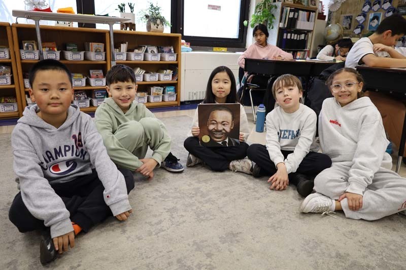 Students sitting on carpet.