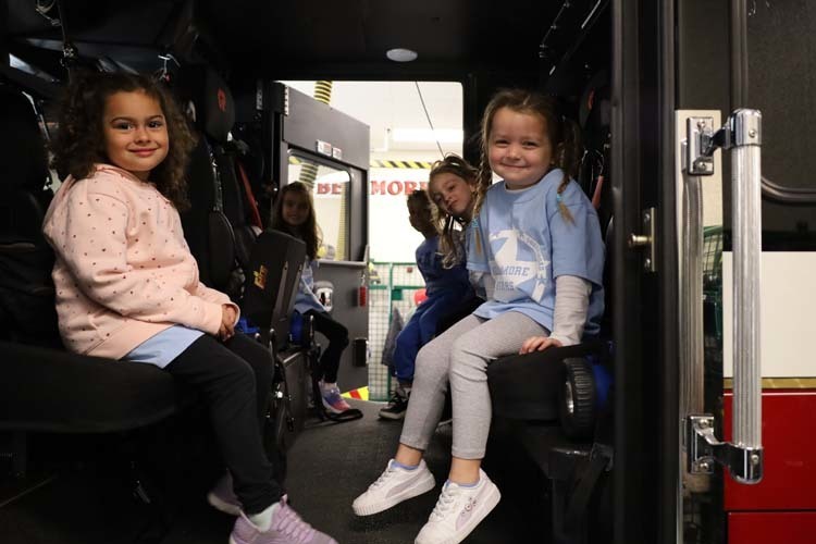 Students sitting in fire truck.