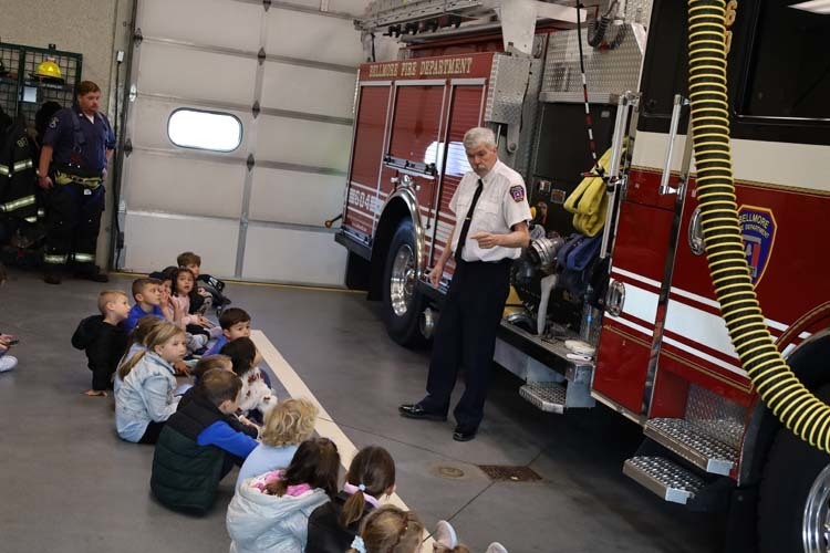 Students sitting in fire truck.