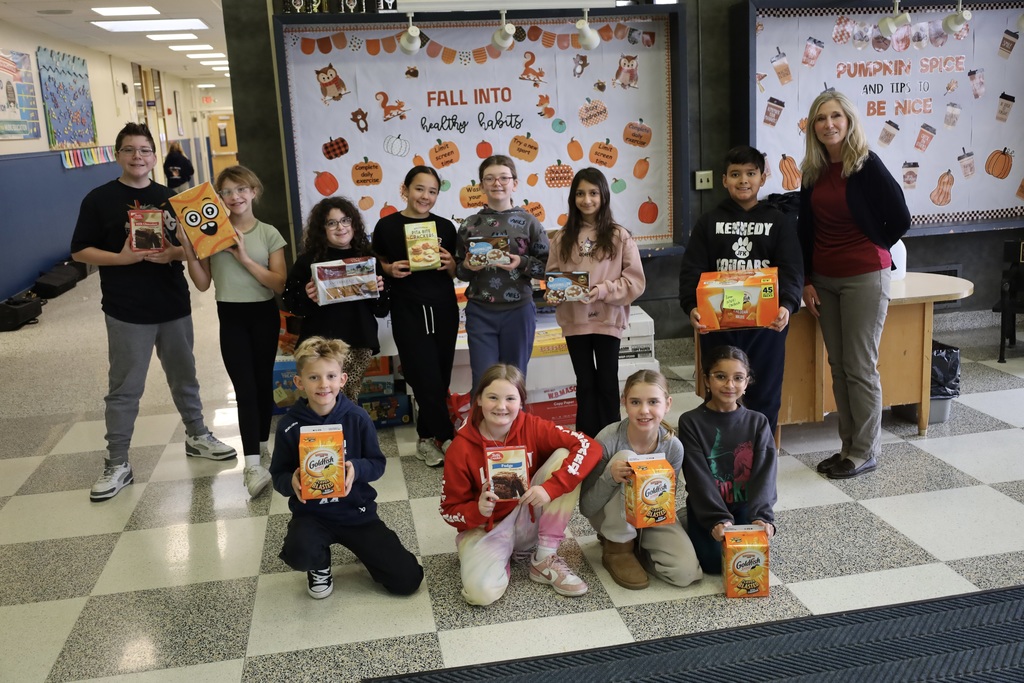 Students holding their donations in hallway.