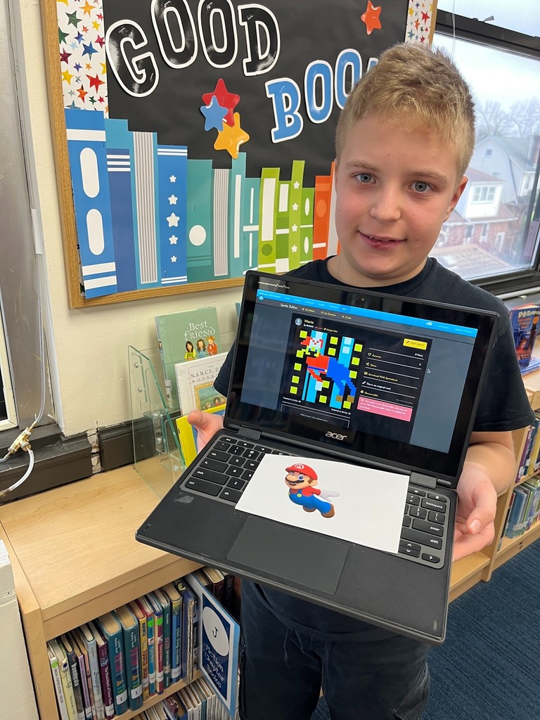 Student holding computer.