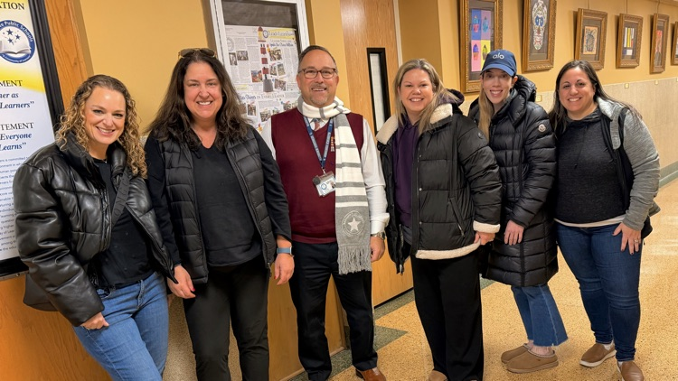 pta members and Dr Joe standing in hallway 