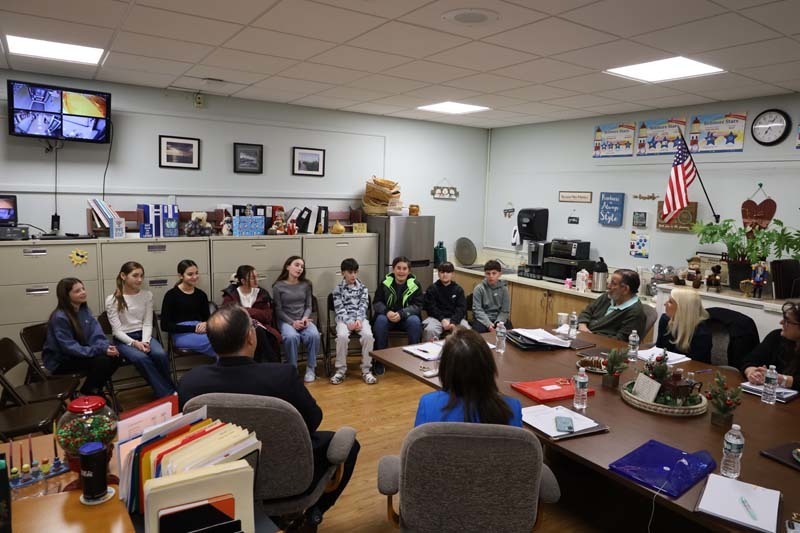 Students sitting in a circle in classroom.