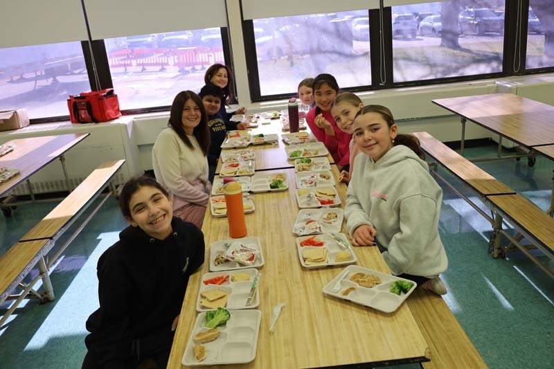 Students sitting at lunch table.