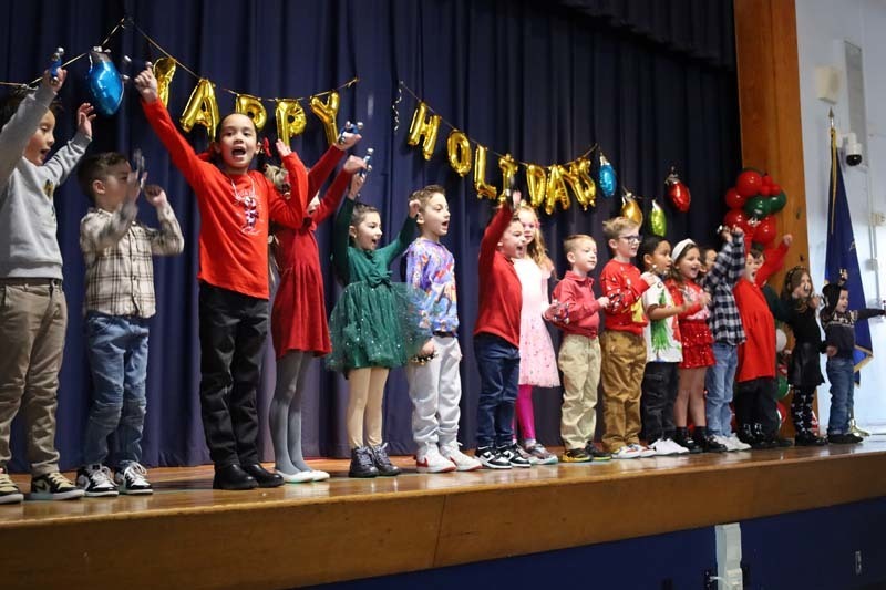 Students singing on stage.